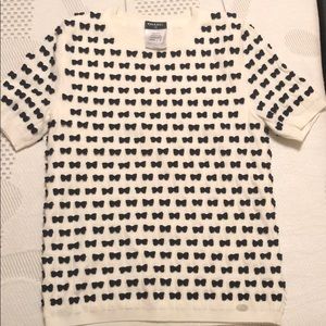 Chanel white top with black bows.